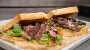 Skirt Steak mit konfiertem Knoblauch – knuspriges Weißbrot, Rucola & Parmesan